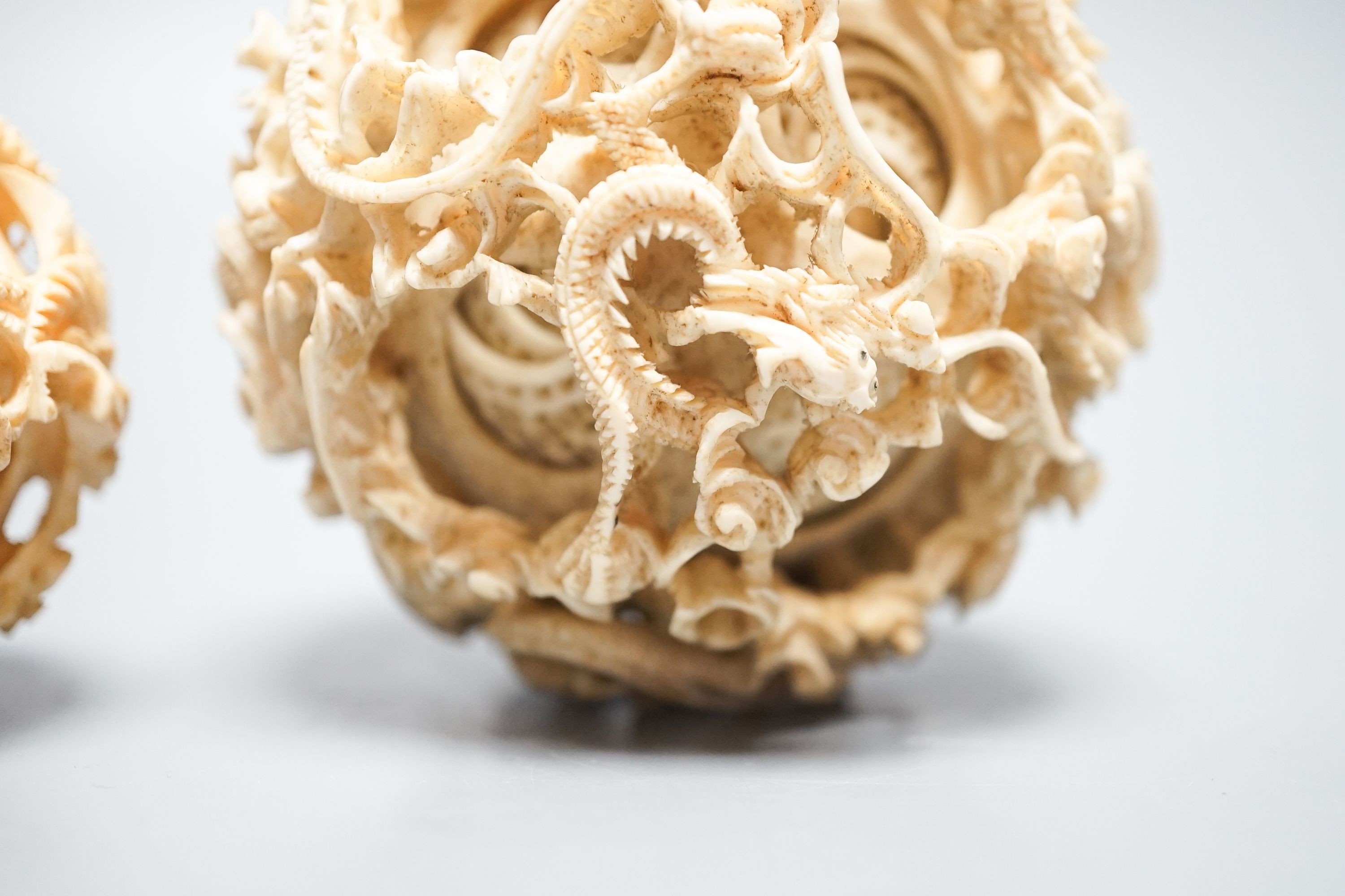 Two Chinese concentric ivory puzzle balls, first half 20th century, largest 8.6cm
